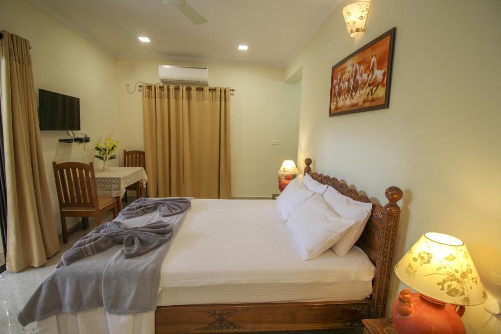 Postel nebo postele na pokoji v ubytování Primavera Holiday Homes-FAMILY RUN GOAN GUEST HOUSE