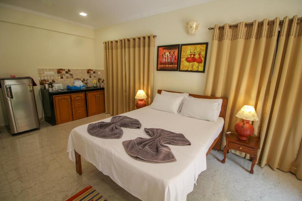 Postel nebo postele na pokoji v ubytování Primavera Holiday Homes-FAMILY RUN GOAN GUEST HOUSE
