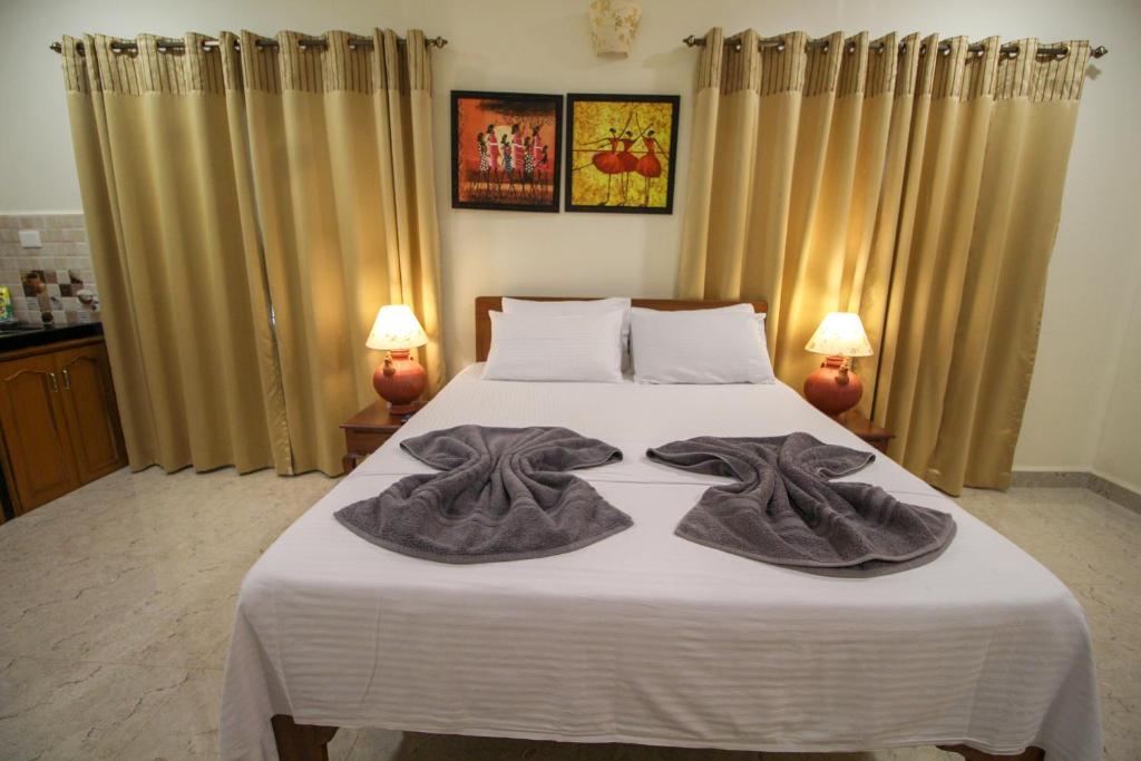 Postel nebo postele na pokoji v ubytování Primavera Holiday Homes-FAMILY RUN GOAN GUEST HOUSE