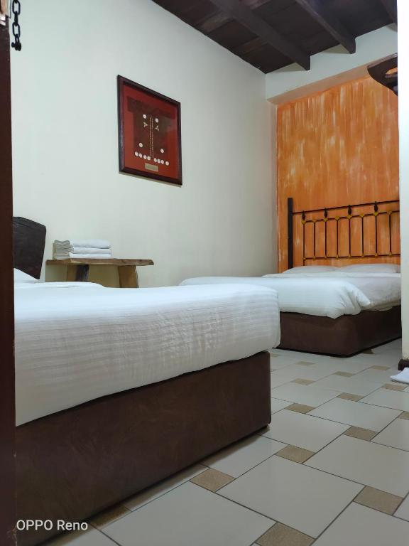 Postel nebo postele na pokoji v ubytování Kuching Waterfront Lodge