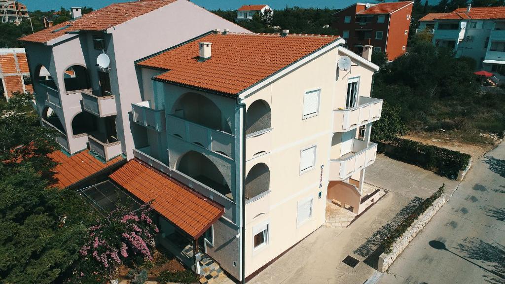 an overhead view of a white building with a red roof at Apartments Matin in Novalja