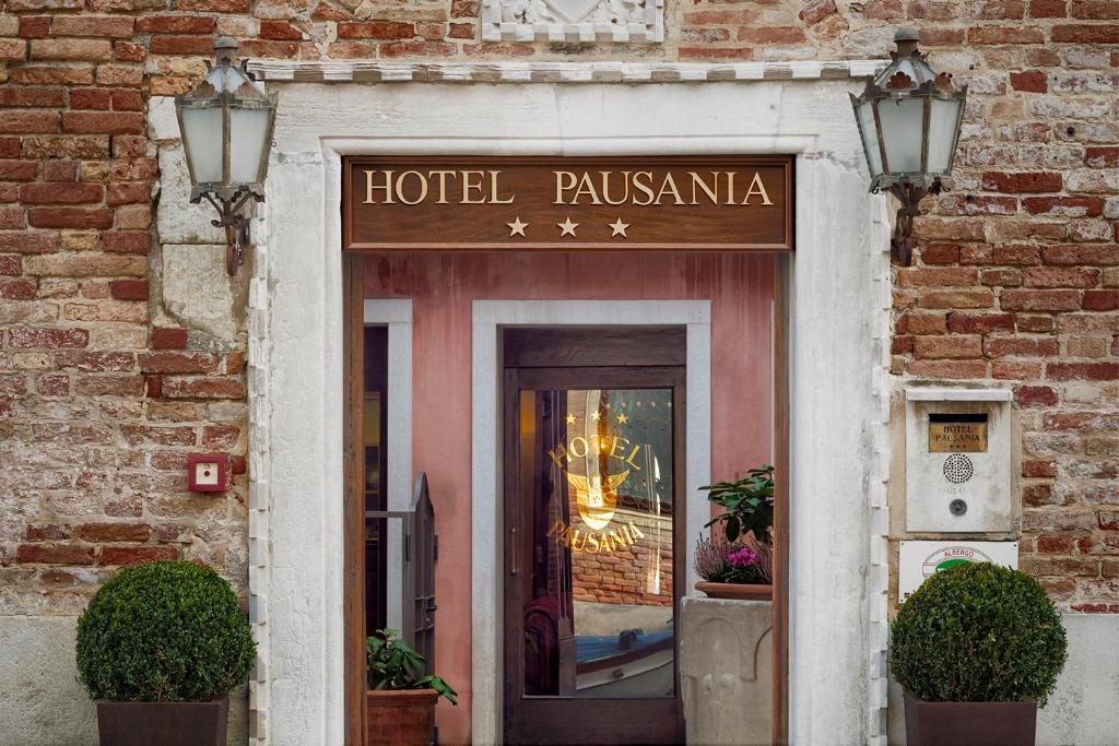 a hotel pazaemia sign over the door of a building at Hotel Pausania in Venice
