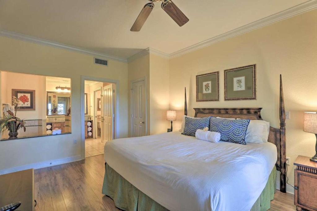 a bedroom with a large white bed with blue pillows at Golf Resort Condo, Reunion Resort in Kissimmee
