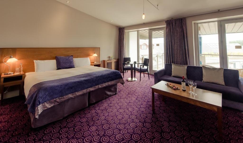 a hotel room with a bed and a couch at Osprey Hotel in Naas