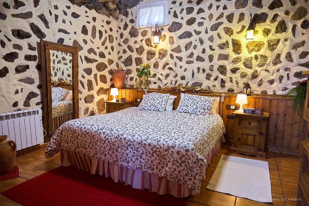 a bedroom with a bed with a animal print wall at Amazing Country House with Ocean View, Cueva de la Arena in Garachico