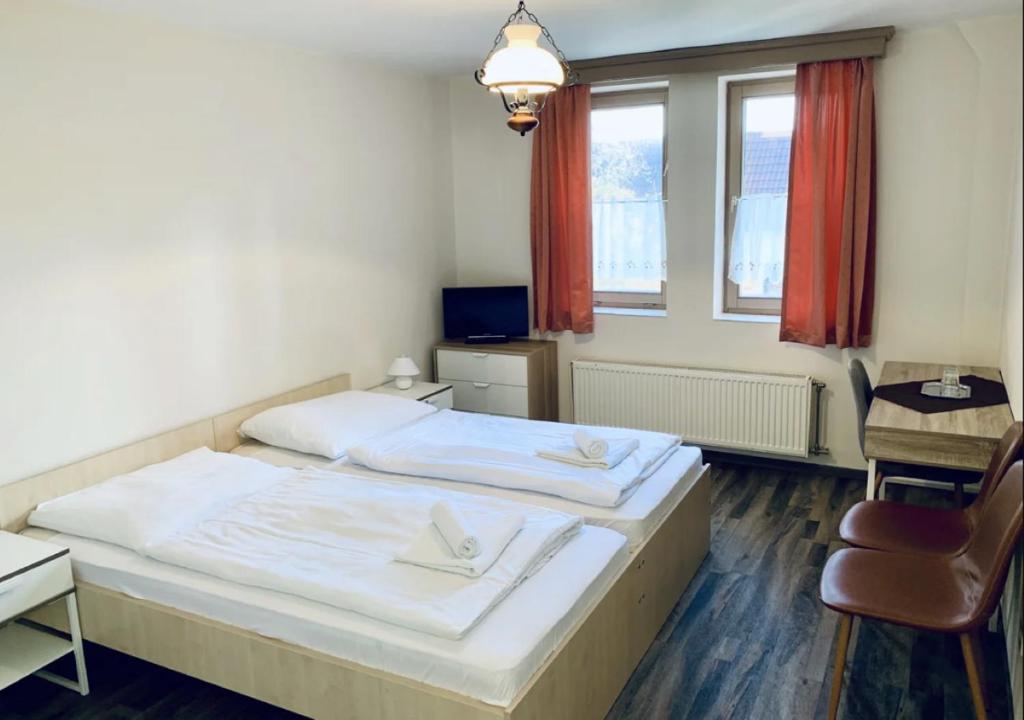 A bed or beds in a room at Révész Hotel, Restaurant and Rosa Spa