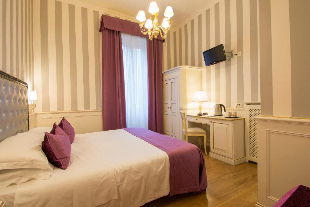 Postel nebo postele na pokoji v ubytování Hotel Pedrini