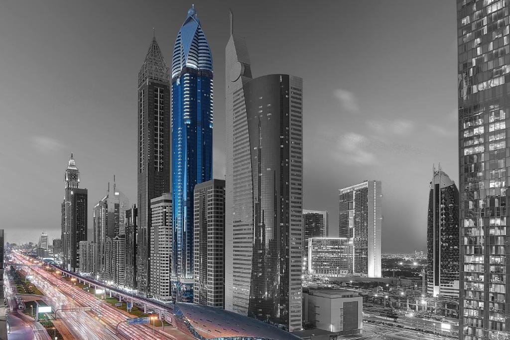 a city skyline with tall buildings and a freeway at Rose Rayhaan by Rotana - Dubai in Dubai