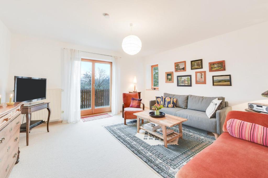 a living room with a couch and a tv at Ferienwohnung Keul in Samerberg