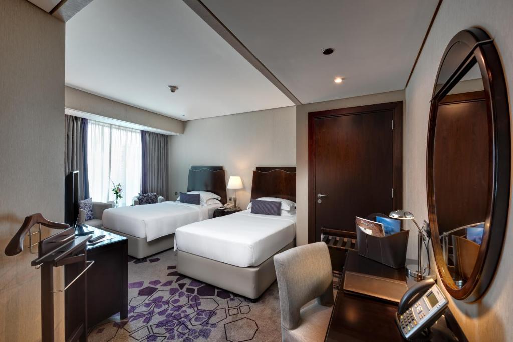 Postel nebo postele na pokoji v ubytování Rose Rayhaan by Rotana - Dubai