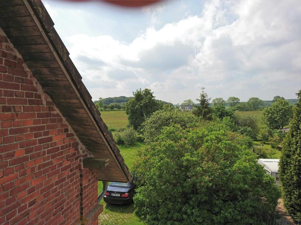 a view from the side of a brick building with a car at Ferienwohnung Ralswiek, Jarnitz 8 in Jarnitz