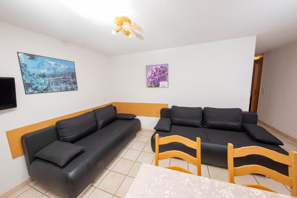 a living room with a couch and a table at Haus Alfa in Saas-Fee