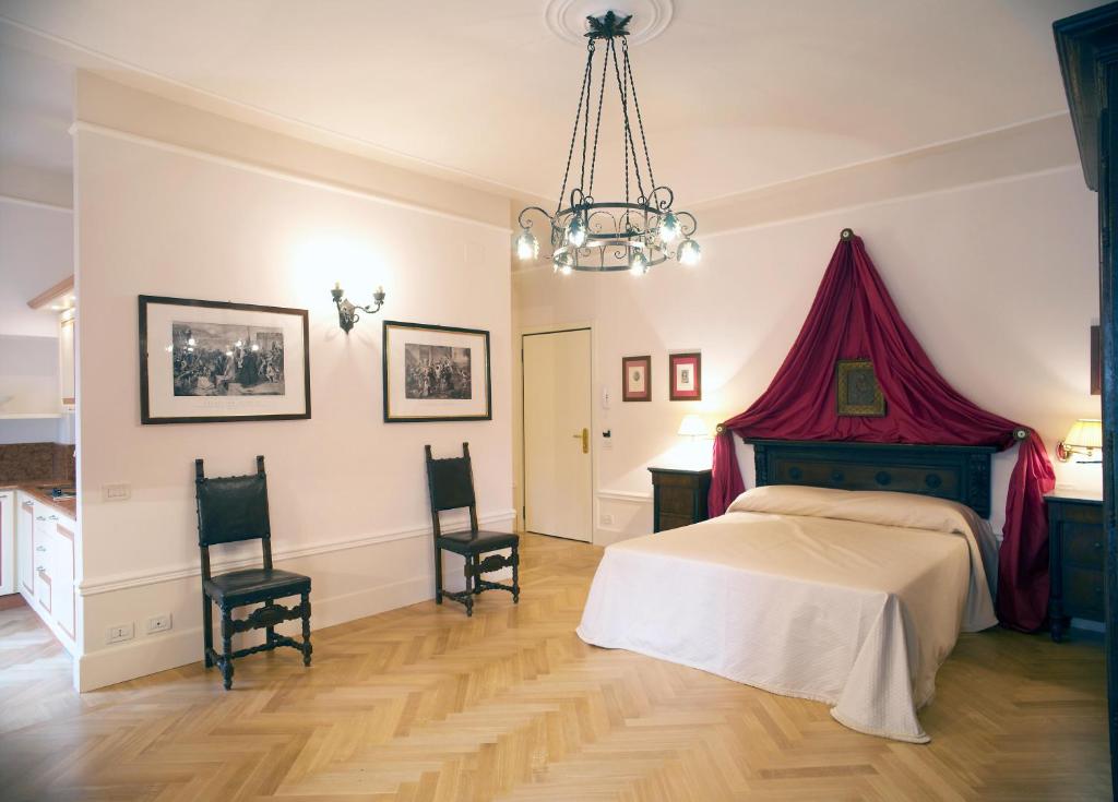 Postel nebo postele na pokoji v ubytování Palazzo Dalla Rosa Prati