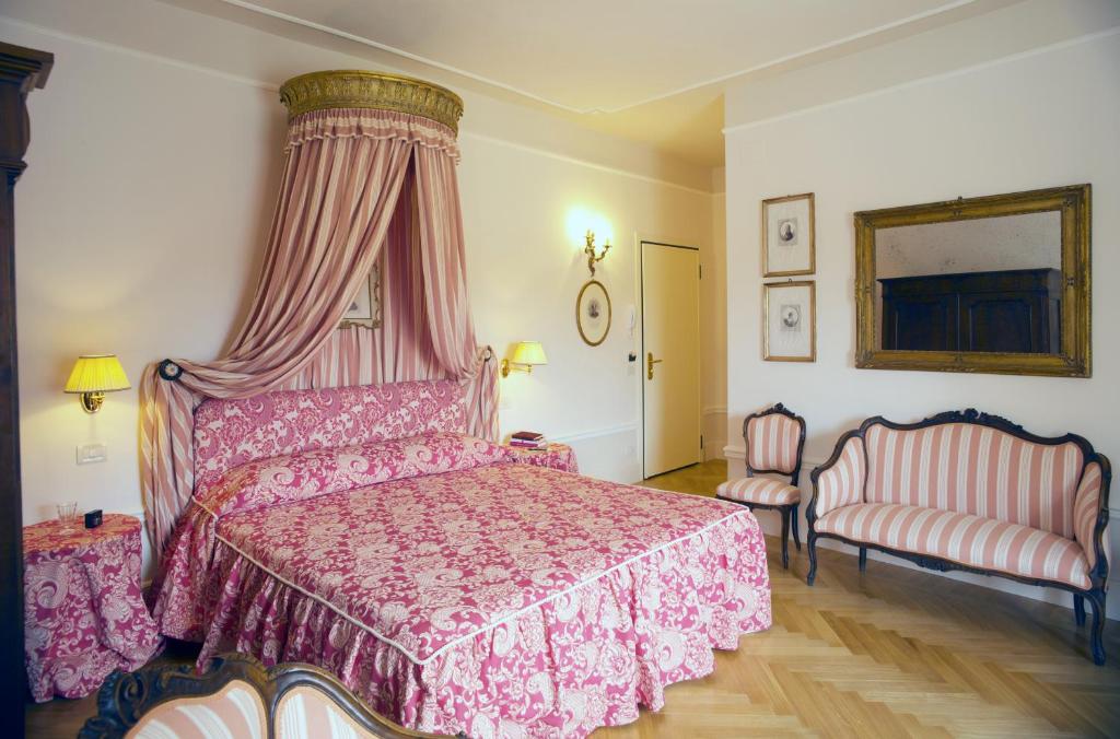 Postel nebo postele na pokoji v ubytování Palazzo Dalla Rosa Prati
