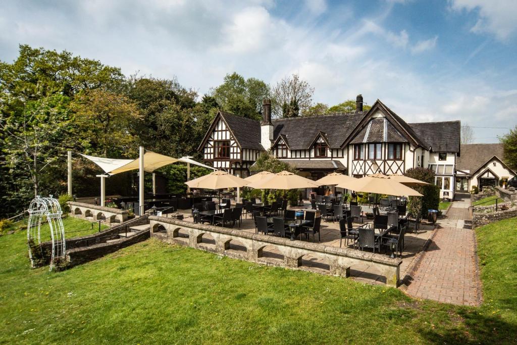 a large house with tables and chairs in front of it at The Bentley Brook Inn in Thorpe