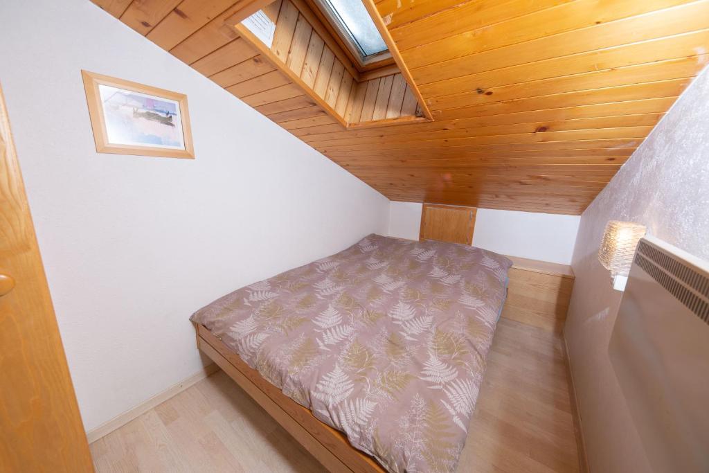 a small room with a bed in a attic at Haus Alfa in Saas-Fee