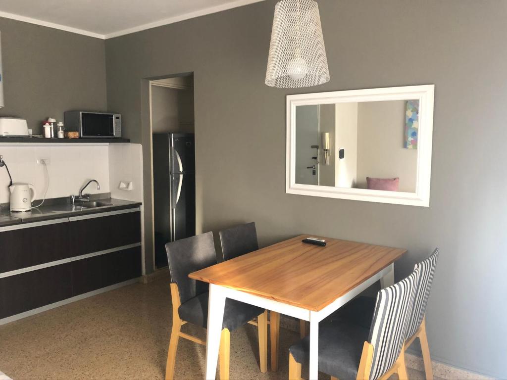 a kitchen with a wooden table and chairs and a sink at Apartment Lam62 in Bahía Blanca