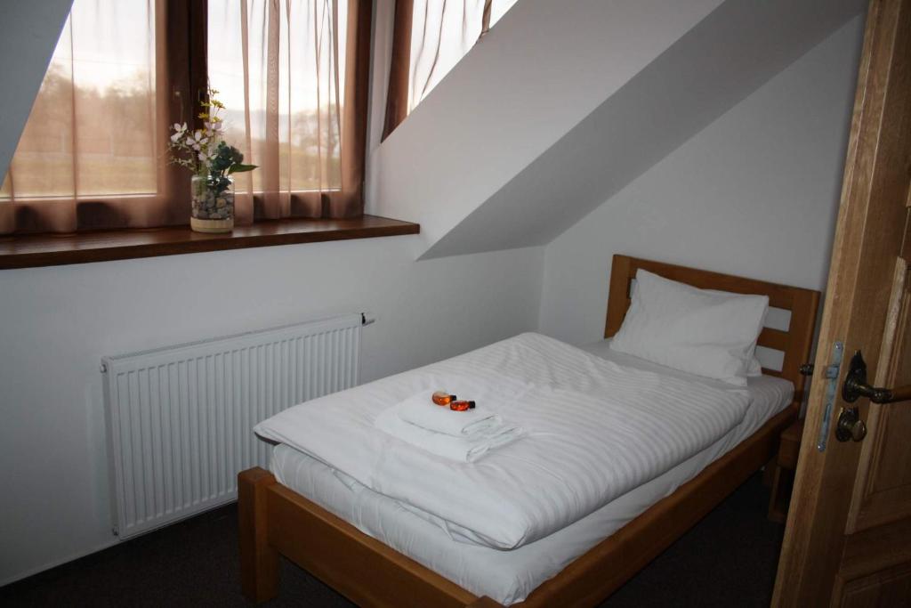 Postel nebo postele na pokoji v ubytování Hotel Farma Vysoká