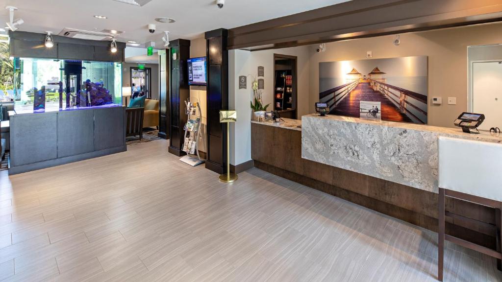 a lobby of a restaurant with a counter and a bar at Staybridge Suites - Naples - Marco Island by IHG in Naples