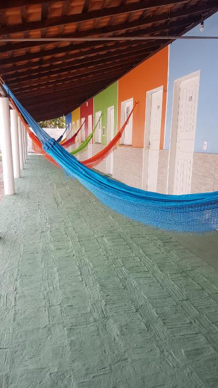 a blue hammock on the floor of a building at Pousada Andorinhas in Santo Amaro