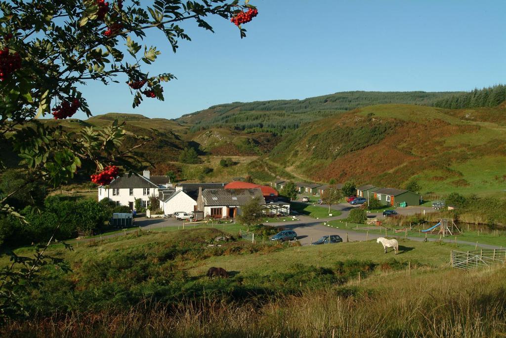 a small town in a valley with hills at Cologin in Oban