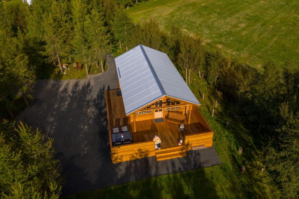 an overhead view of a house with a metal roof at Áshóll guesthouse - farmstay in Akureyri