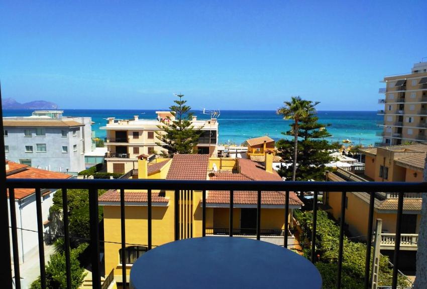 a balcony with a view of the ocean and buildings at Hotel Villa Barbara in Can Picafort