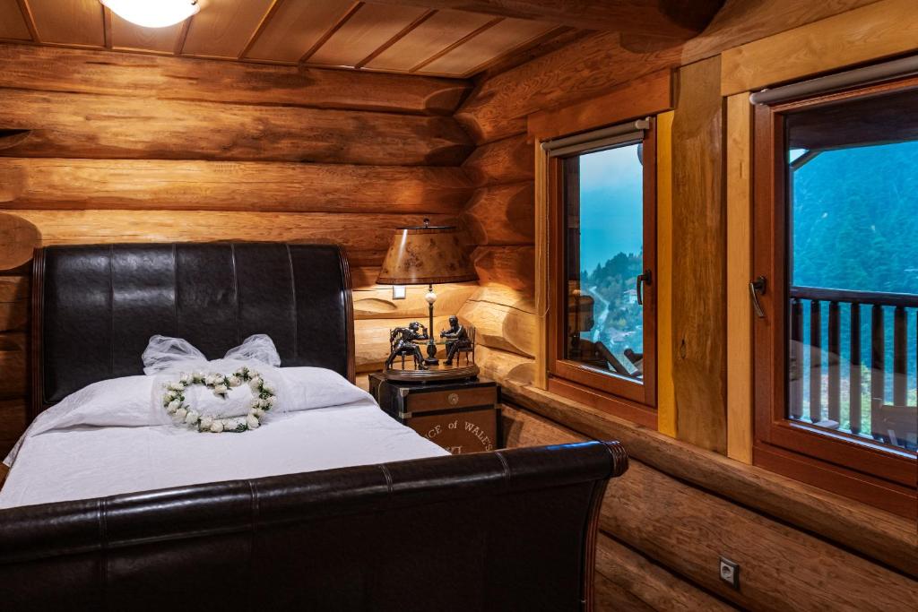 A bed or beds in a room at Mythica Chalet
