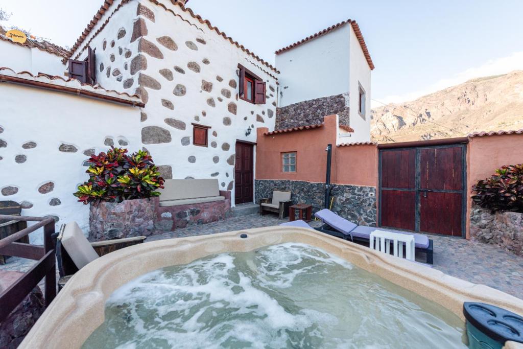 a hot tub on the patio of a house at Casa la Era in San Bartolomé