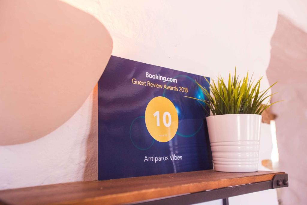 a box on a table with a potted plant at Antiparos Vibes in Agios Georgios