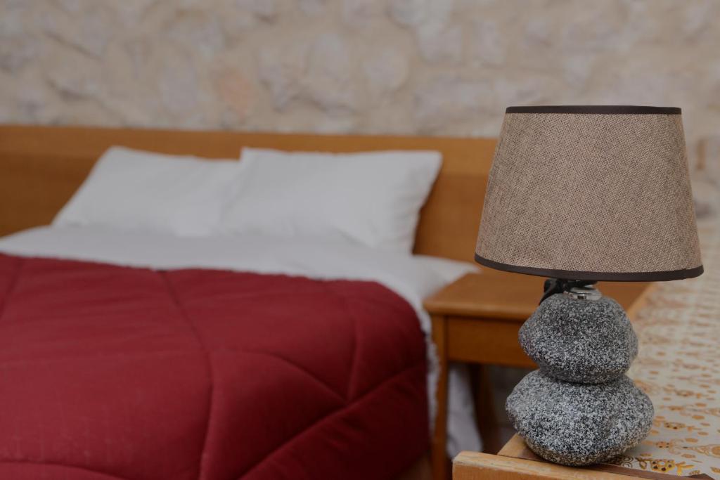 a lamp sitting on a night stand next to a bed at Petra Lion Hotel in Wadi Musa