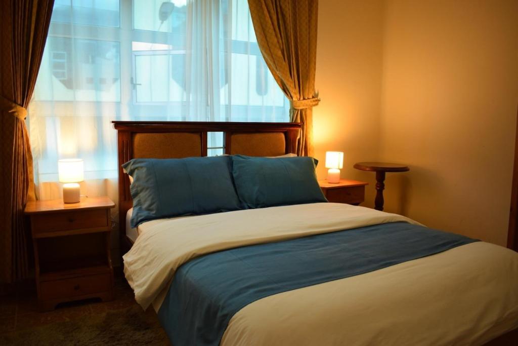 Postel nebo postele na pokoji v ubytování Meraki Hotel