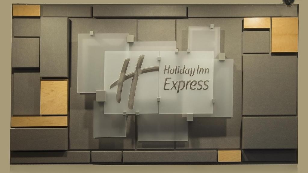 napis z napisem „Holiday Inn Express” na ścianie w obiekcie Holiday Inn Express - San Antonio Airport, an IHG Hotel w mieście San Antonio