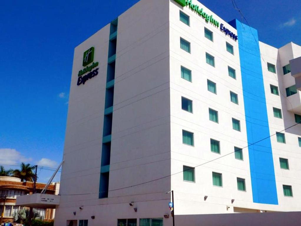 a white building with a sign on the side of it at Holiday Inn Express Tuxtla Gutierrez La Marimba, an IHG Hotel in Tuxtla Gutiérrez