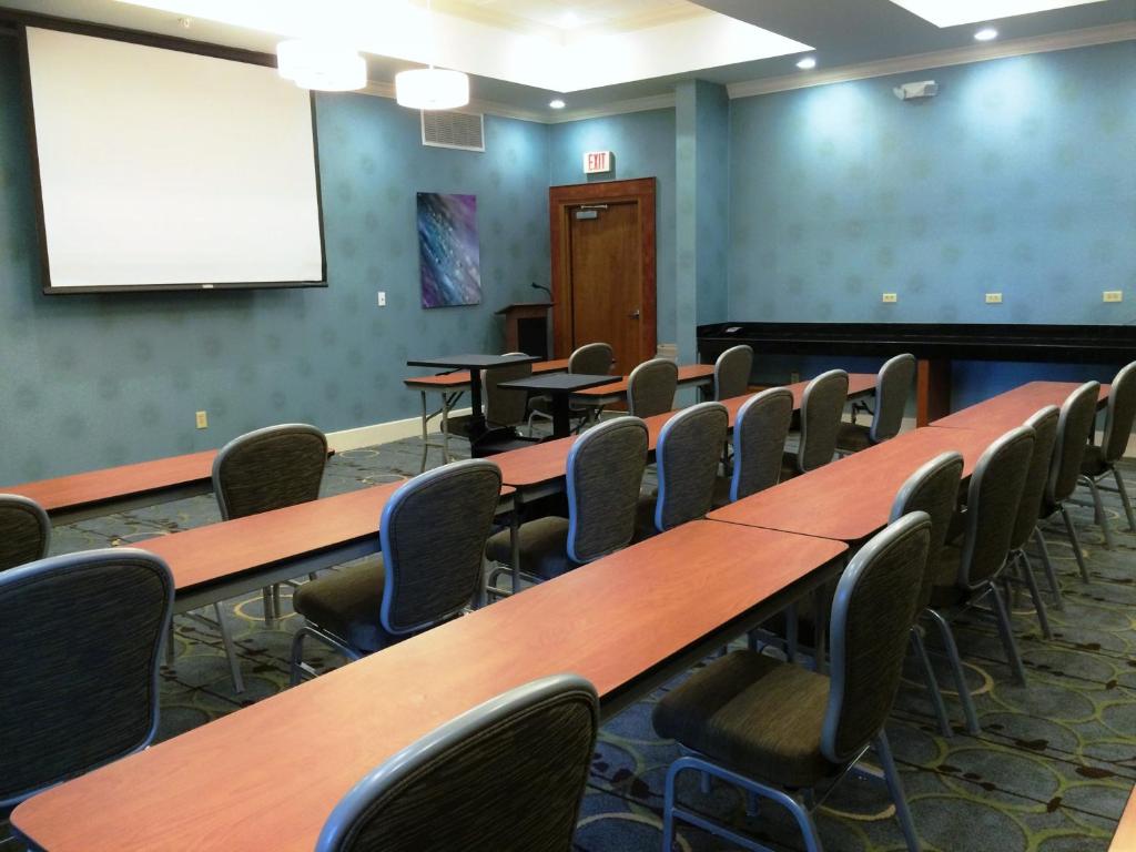 a conference room with tables and chairs and a whiteboard at Holiday Inn Santee by IHG in Santee