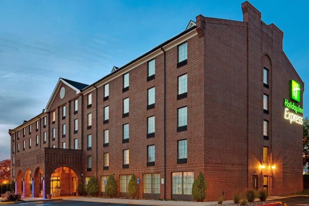a large brick building with a sign on it at Holiday Inn Express Harrisburg East by IHG in Harrisburg