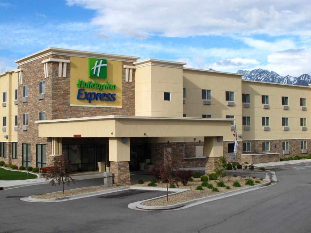 ein Hotel mit einem Schild auf der Vorderseite eines Gebäudes in der Unterkunft Holiday Inn Express Salt Lake City South - Midvale, an IHG Hotel in Midvale