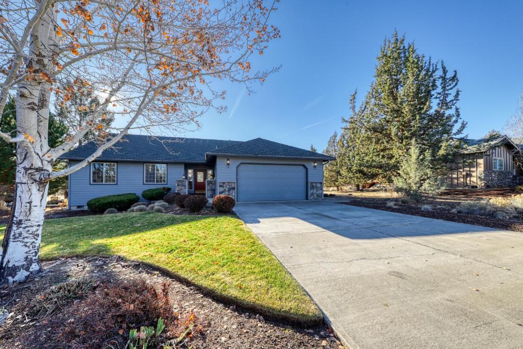 a house with a driveway and a garage at Eagle Crest Nature Retreat in Redmond