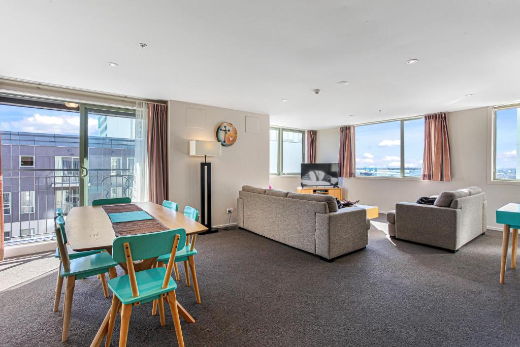 a living room with a couch and a table and chairs at Apartment in the heart of the city in Christchurch