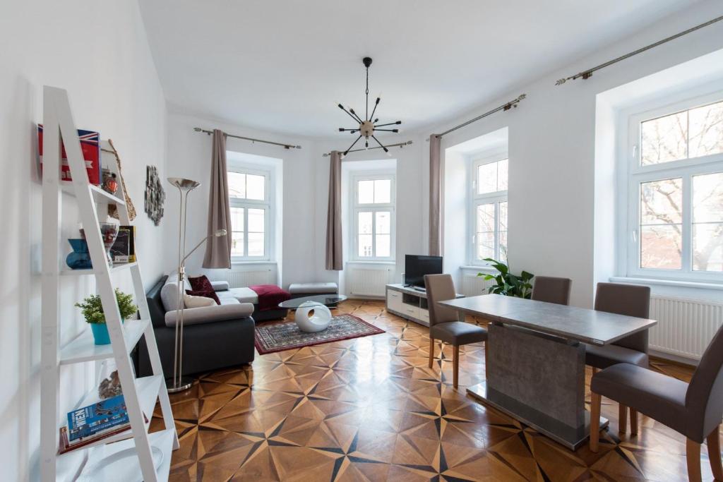 a living room with a table and chairs at Belvedere Central Apartment in Vienna