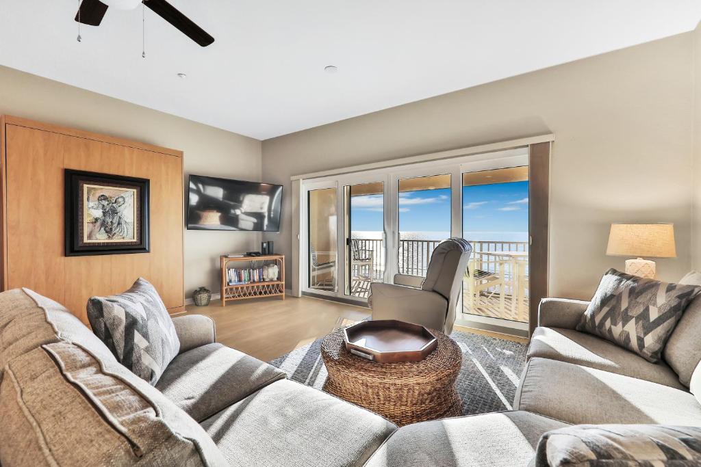 a living room with a couch and a table at Oceanside 404 in Clearwater Beach