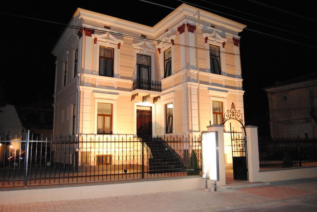 a white house with a fence in front of it at Villa Bastion in Bitola