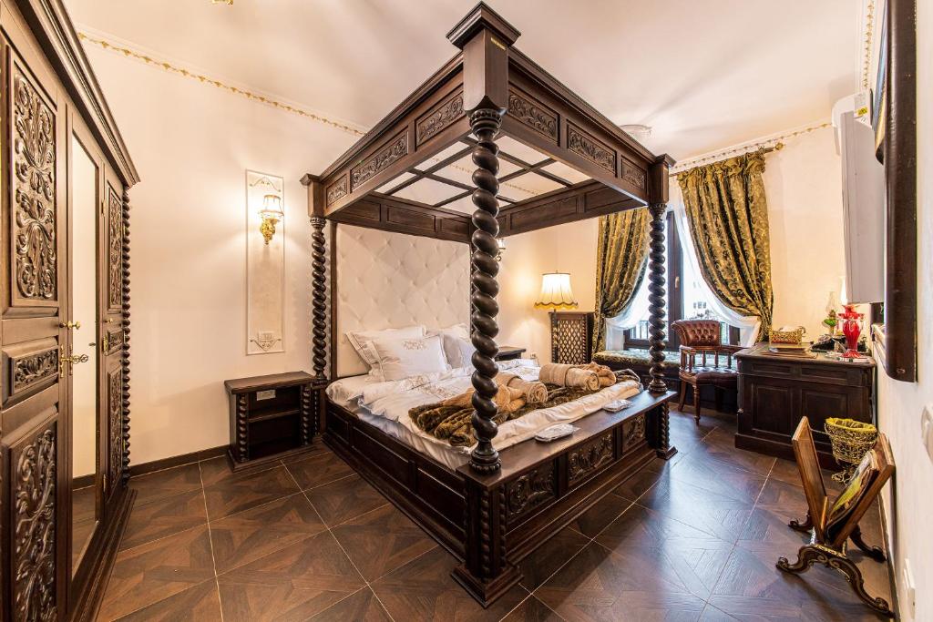 a bedroom with a canopy bed in a room at USSR Apartment in Bucharest