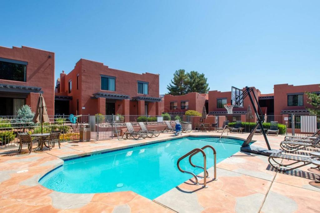a swimming pool with chairs and a swing at Bell Rock Inn in Sedona