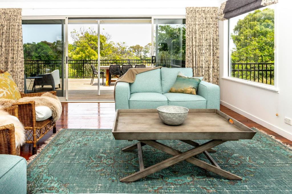 a living room with a blue couch and a coffee table at The House at No 1 in Havelock North