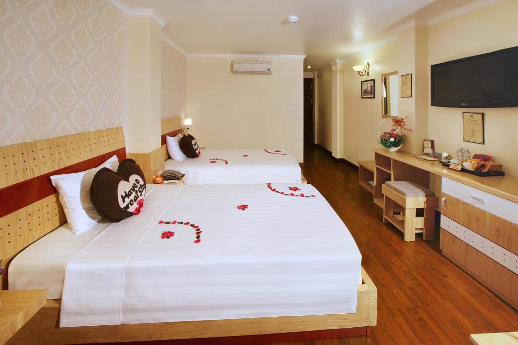 Postel nebo postele na pokoji v ubytování Hanoi House Hostel & Travel