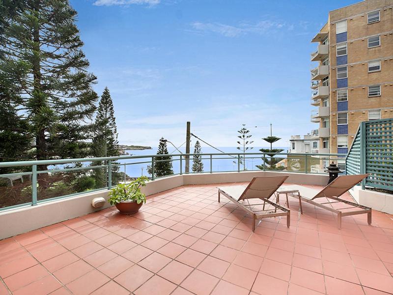 a balcony with two chairs and a table on a patio at AeA The Coogee View in Sydney