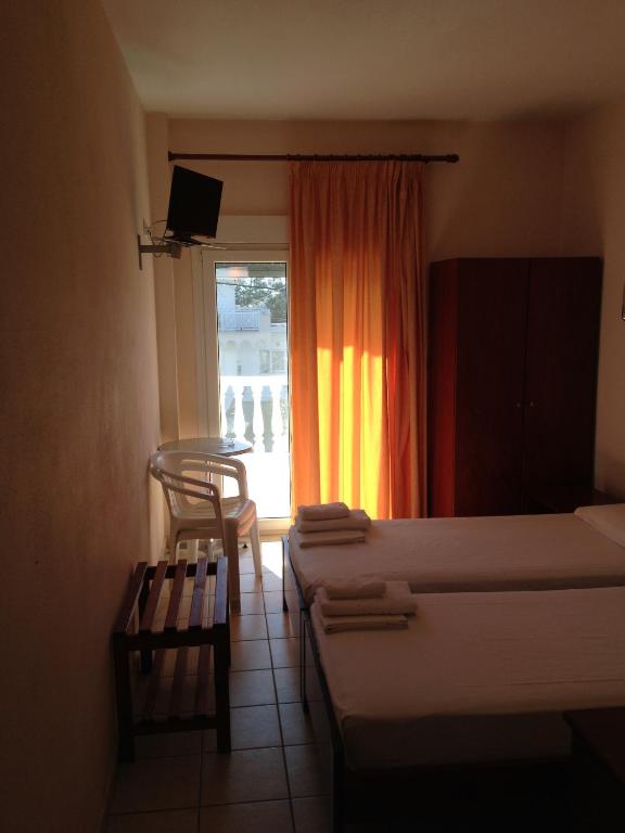 Postel nebo postele na pokoji v ubytování Hotel Akrogiali