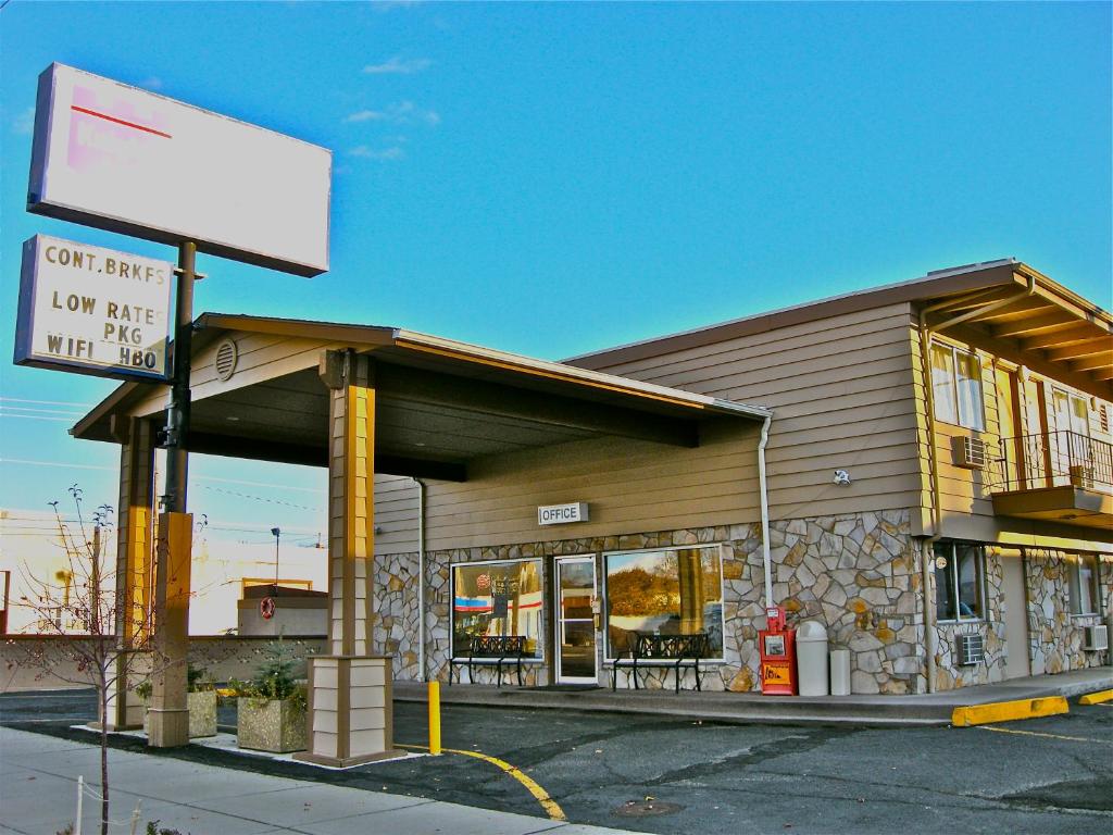 a gas station with a sign in front of it at Knights Inn - Baker City in Baker City