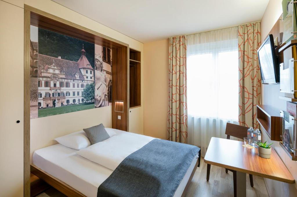 Postel nebo postele na pokoji v ubytování JUFA Hotel Graz City